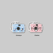 Add a playful touch to your collection with the DAY OFF AIRLINE: D.O ZZirang-e &amp; Charles - Toy Camera.