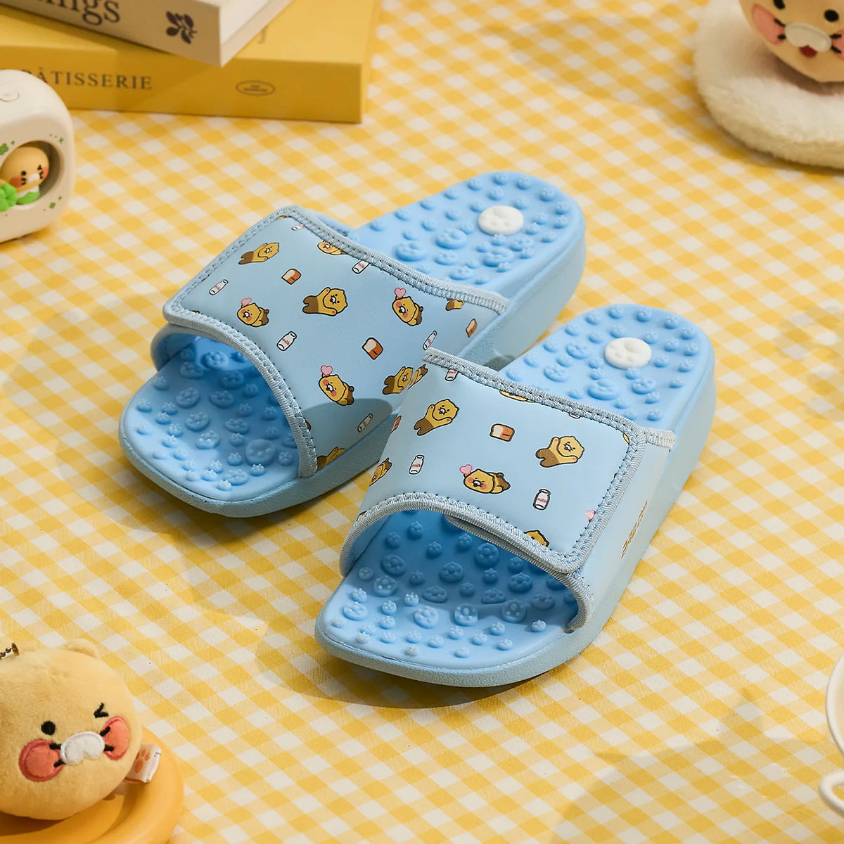 Add a playful touch to your everyday comfort with the Kakao Friends x Ballop - Chunsik Caloring Kok-Kok Acupressure Slippers.