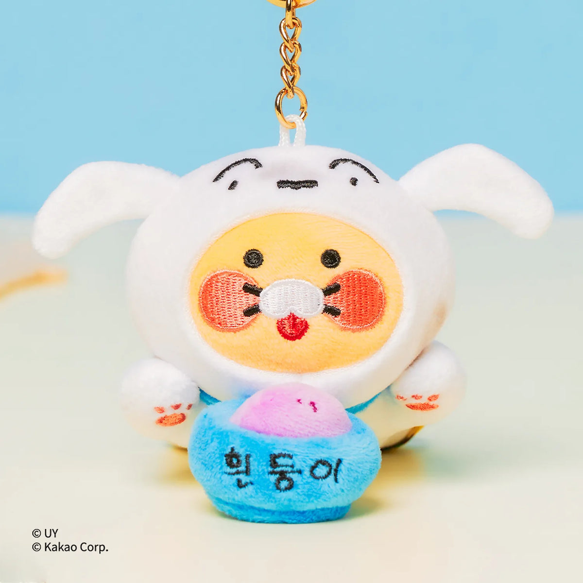 Add a playful touch to your bags and everyday essentials with the Kakao Friends x Crayon Shinchan - Chunsik Shiro Reel Doll Keyring.