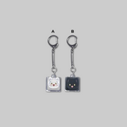 Add a cute and playful touch to your everyday accessories with the Keycap Keyring from The Black Leopard Family's Snow Leopard Baby: Bloom in the Garden.